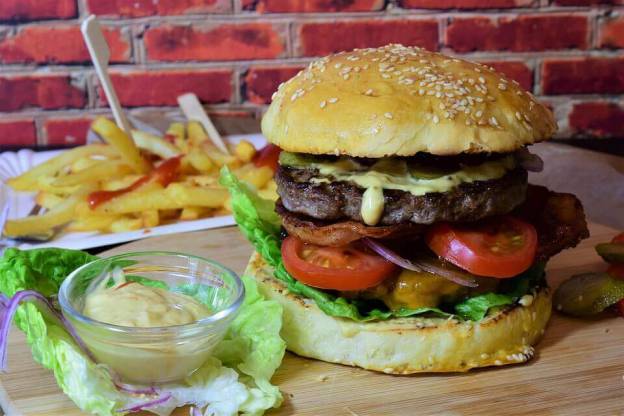 Hamburger with fries in the background