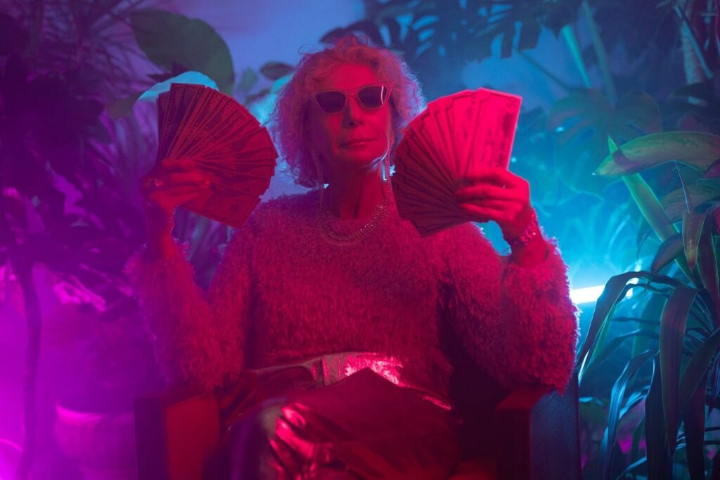 an elderly woman holding money