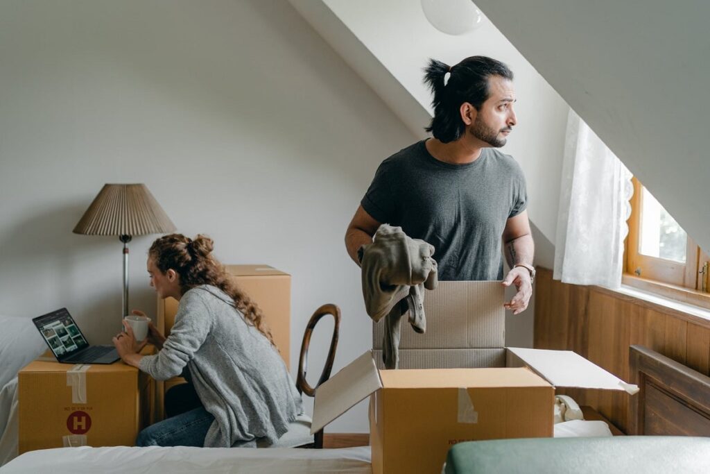 couple packing items into boxes