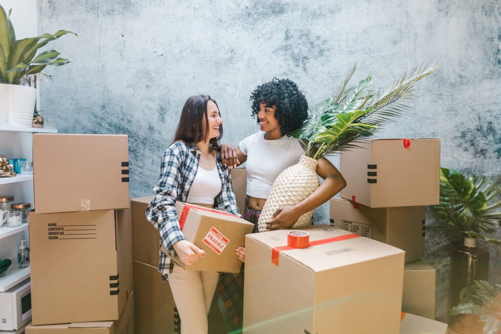 girls hugging next to cardboard boxes